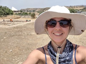 Myself happily covered in ancient dirt at our archaeological site (Kalavasos-tenta seen in the background)